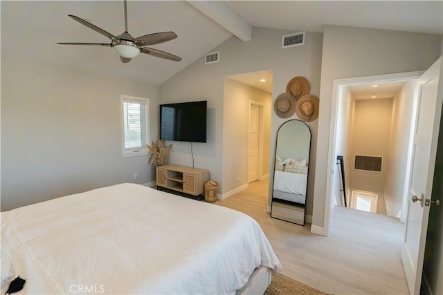 bedroom featuring baseboards, visible vents, lofted ceiling with beams, and light wood finished floors