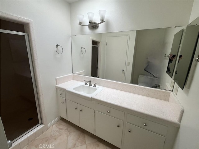 full bathroom with toilet, marble finish floor, a stall shower, and vanity