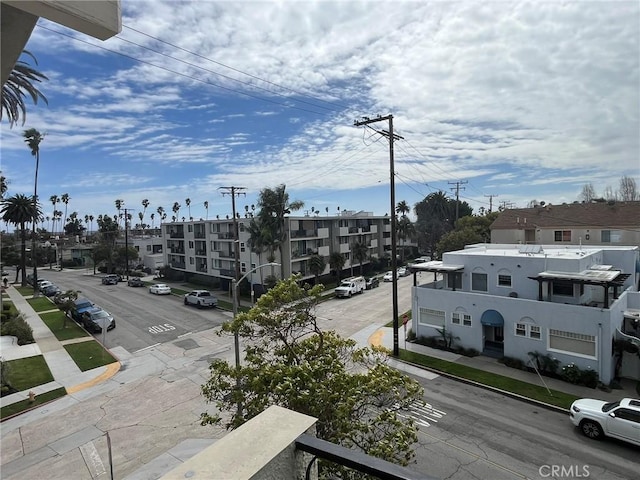 view of street featuring sidewalks, street lights, and curbs