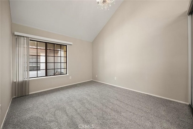 carpeted spare room with a chandelier, high vaulted ceiling, and baseboards