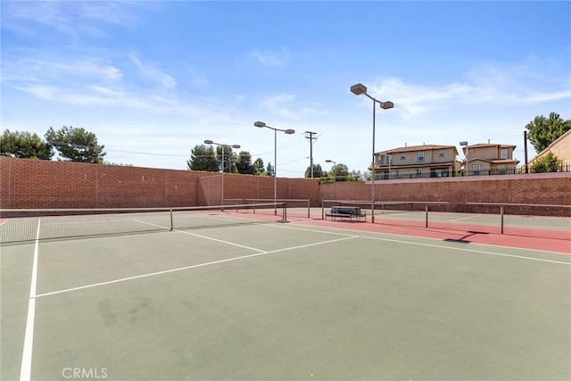 view of sport court with fence