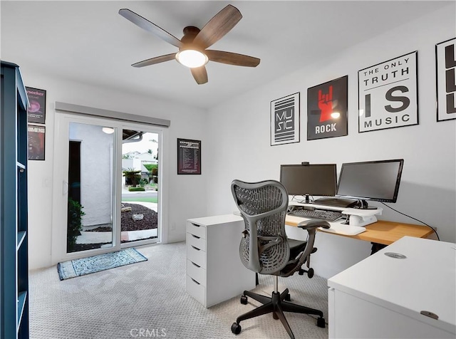 office featuring a ceiling fan and light carpet