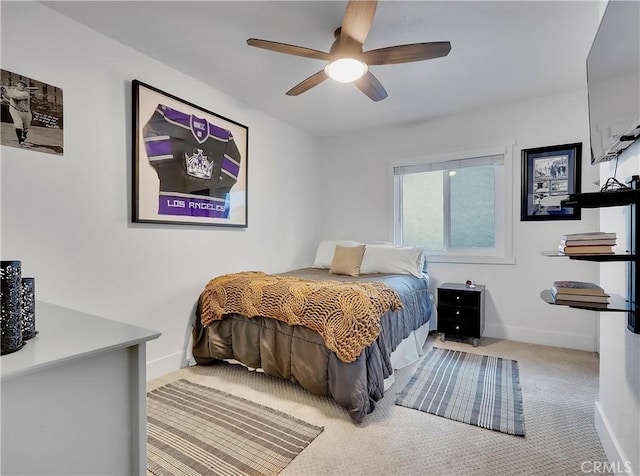 carpeted bedroom with a ceiling fan and baseboards