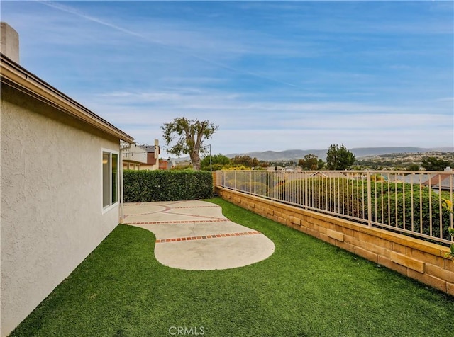 view of yard featuring a patio area and a fenced backyard