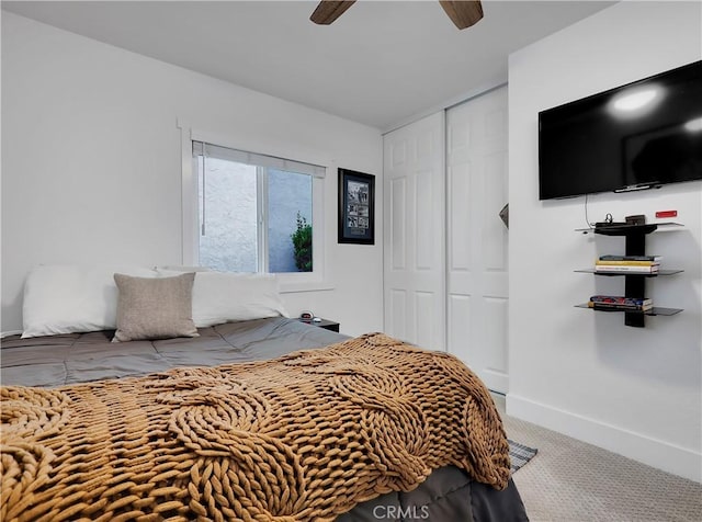 bedroom with a ceiling fan, a closet, baseboards, and carpet flooring