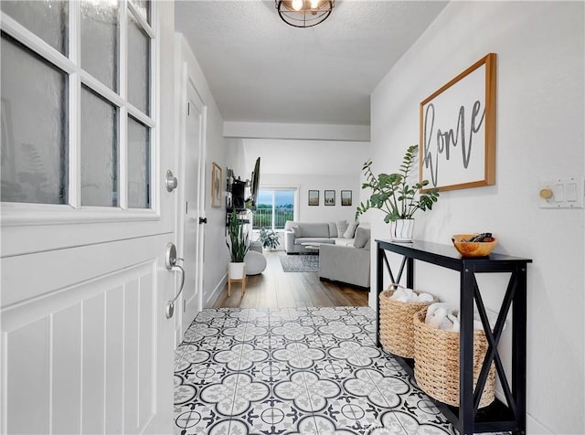 foyer with a textured ceiling and wood finished floors