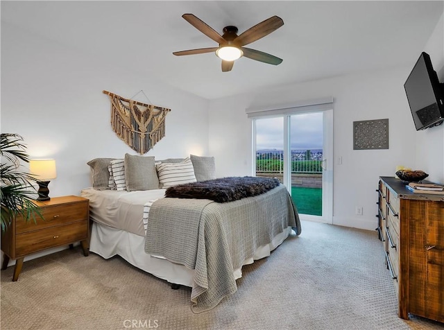 bedroom with a ceiling fan, access to outside, light carpet, and baseboards