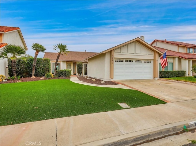 view of front of property with a garage, concrete driveway, board and batten siding, and a front lawn