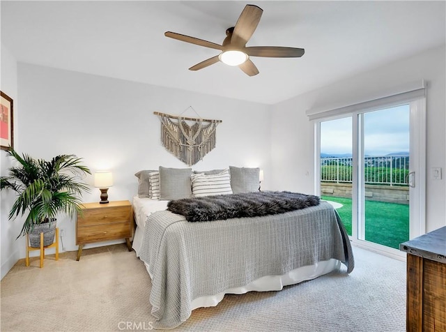 carpeted bedroom featuring a ceiling fan and access to exterior