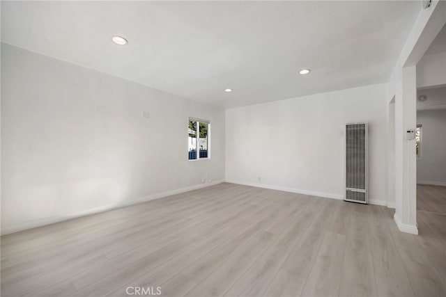 empty room with recessed lighting, visible vents, light wood-style flooring, and baseboards