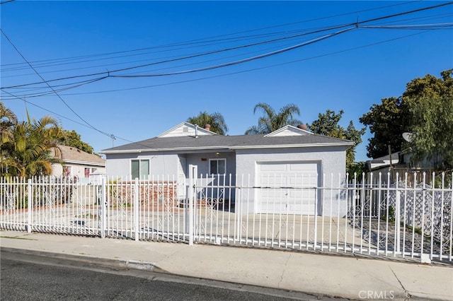 single story home with a garage, driveway, a fenced front yard, and stucco siding