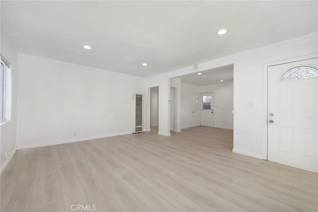 unfurnished living room with baseboards, light wood-style flooring, and recessed lighting