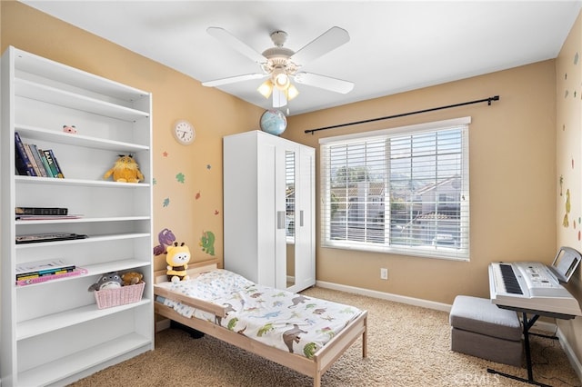 bedroom with carpet flooring, a ceiling fan, and baseboards