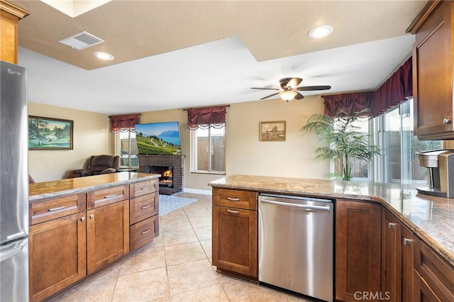 kitchen with visible vents, a peninsula, appliances with stainless steel finishes, open floor plan, and a wealth of natural light