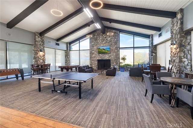 recreation room featuring beam ceiling, visible vents, a fireplace, and high vaulted ceiling