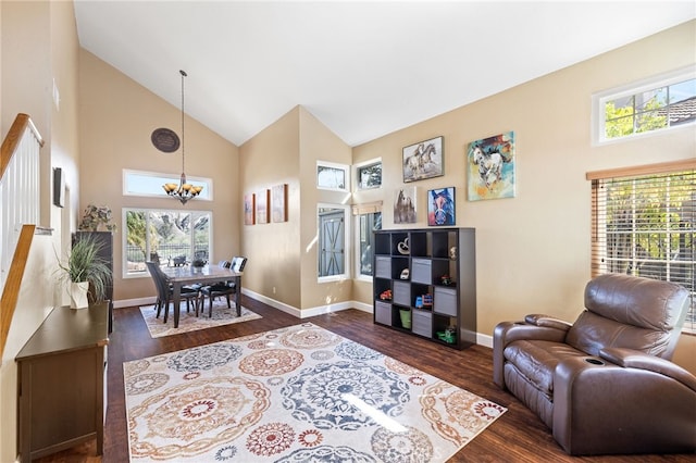 living room featuring plenty of natural light, high vaulted ceiling, an inviting chandelier, and dark wood-style flooring