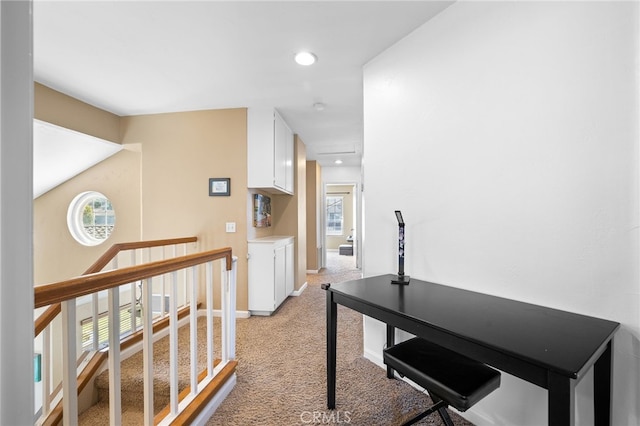 hall with recessed lighting, baseboards, and light colored carpet