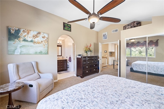 bedroom featuring visible vents, light carpet, arched walkways, and lofted ceiling