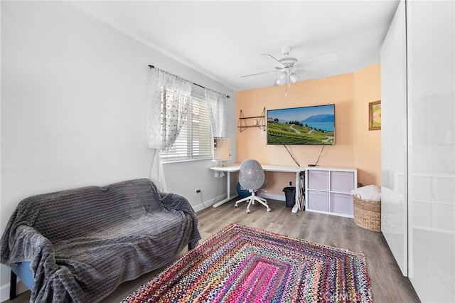 office area with ceiling fan, baseboards, and wood finished floors