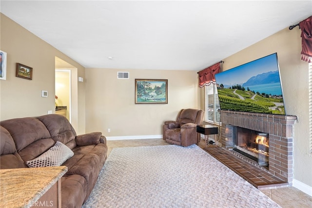 living room featuring light carpet, visible vents, a fireplace, and baseboards