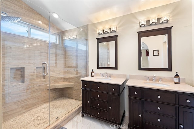 bathroom with a sink, two vanities, marble finish floor, and a shower stall