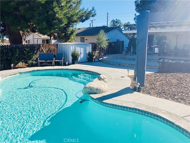 view of swimming pool featuring fence, a fenced in pool, and a patio