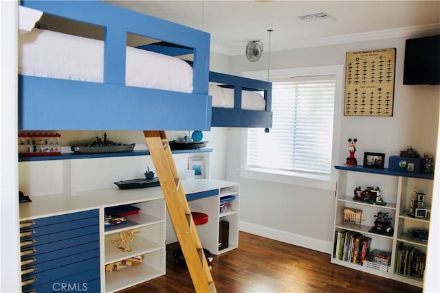 bedroom featuring baseboards, visible vents, wood finished floors, and ornamental molding