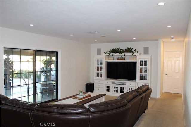 living room featuring recessed lighting, visible vents, baseboards, and light colored carpet