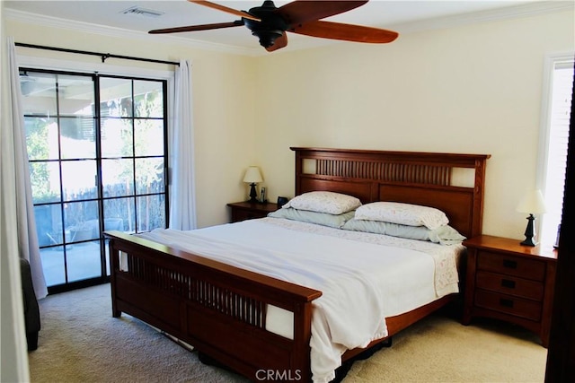 carpeted bedroom featuring a ceiling fan, visible vents, and crown molding