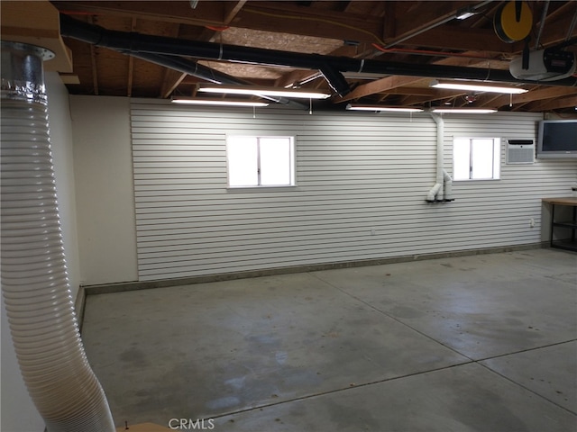below grade area with an AC wall unit and a garage