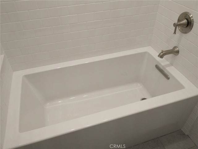 full bath featuring a bathtub and tile patterned floors