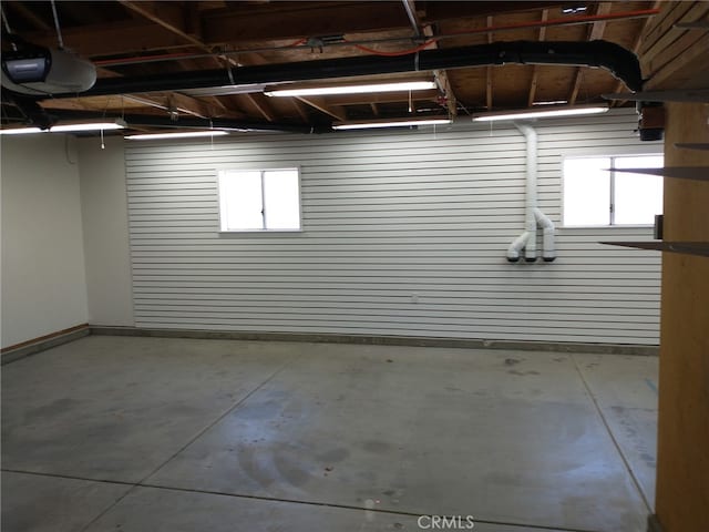 garage featuring baseboards and a garage door opener