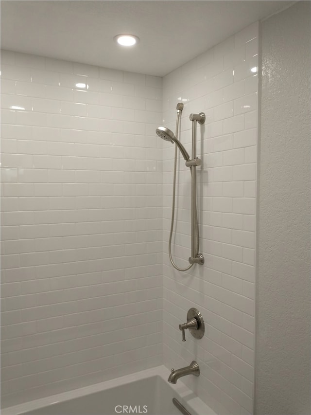 interior details featuring recessed lighting and bathing tub / shower combination