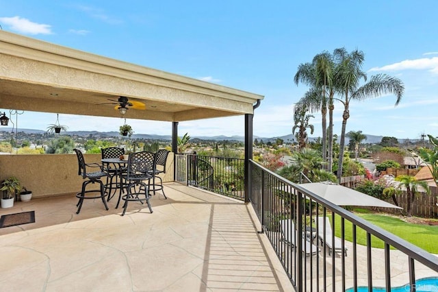 balcony with a mountain view and a ceiling fan