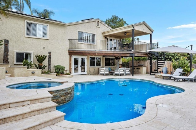 view of swimming pool featuring french doors, outdoor dry bar, stairway, a patio area, and fence