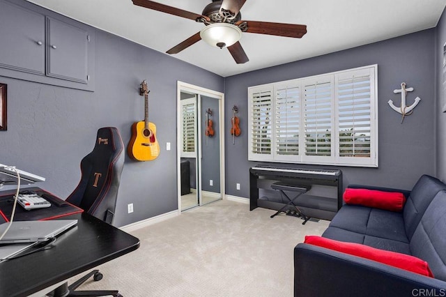 office space with ceiling fan, carpet, and baseboards