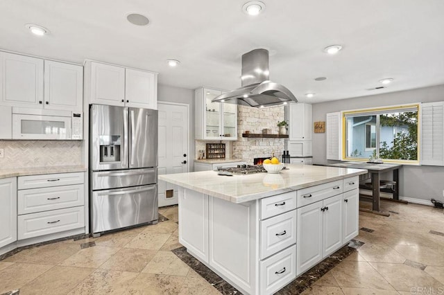 kitchen featuring island range hood, appliances with stainless steel finishes, tasteful backsplash, and recessed lighting