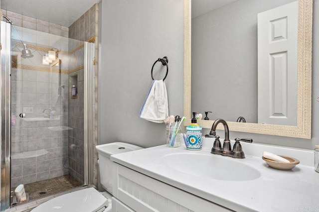 full bath featuring toilet, a shower stall, and vanity