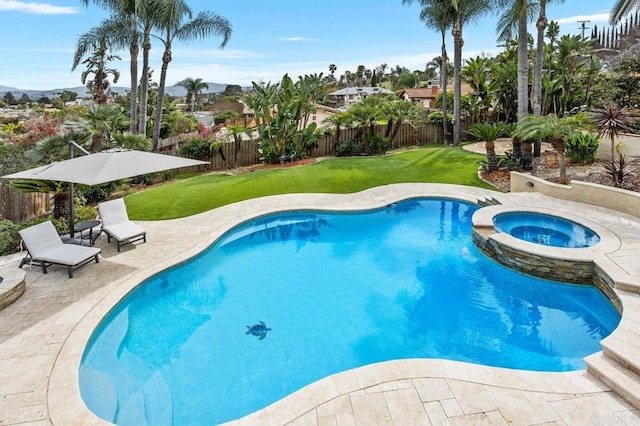 view of swimming pool with a lawn, a patio area, a fenced backyard, and a pool with connected hot tub