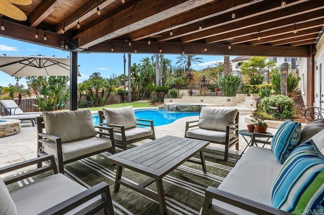 view of patio / terrace with a fenced backyard, a pool with connected hot tub, and outdoor lounge area