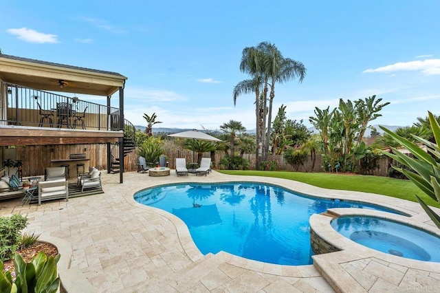 view of swimming pool with a ceiling fan, a fenced backyard, a yard, a patio area, and a pool with connected hot tub