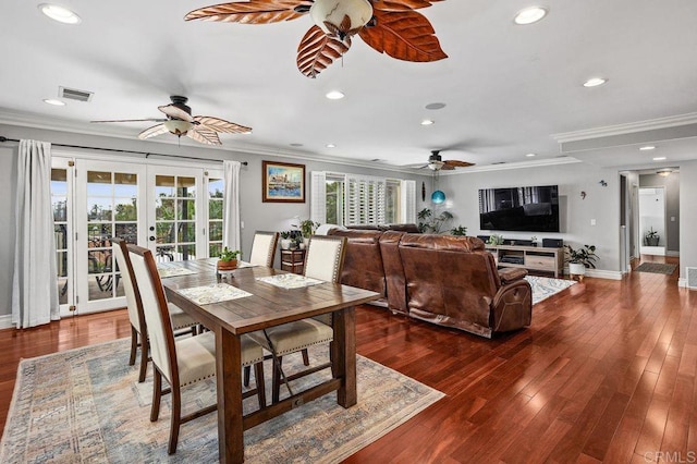 dining room featuring visible vents, ornamental molding, hardwood / wood-style floors, and french doors