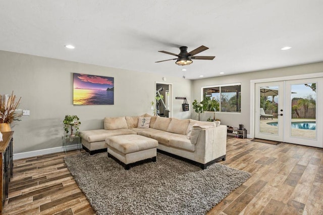 living area featuring french doors, recessed lighting, wood finished floors, and baseboards