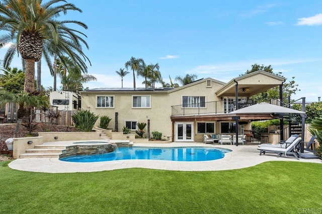 view of pool with a ceiling fan, a lawn, a patio, fence, and french doors