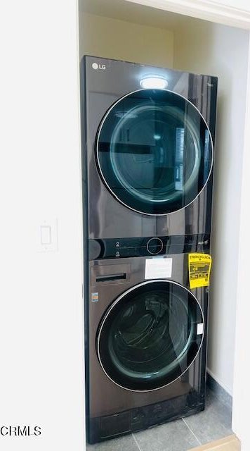 741 S Curson Ave, Los Angeles, CA 90036 - laundry area featuring laundry area, baseboards, tile patterned flooring, and stacked washer / dryer