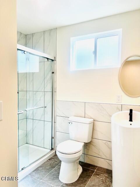 741 S Curson Ave, Los Angeles, CA 90036 - full bathroom featuring a stall shower, toilet, and tile walls