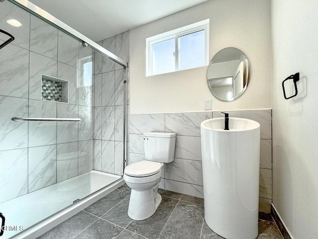 741 S Curson Ave, Los Angeles, CA 90036 - full bathroom featuring tile walls, a shower stall, a sink, a wainscoted wall, and toilet