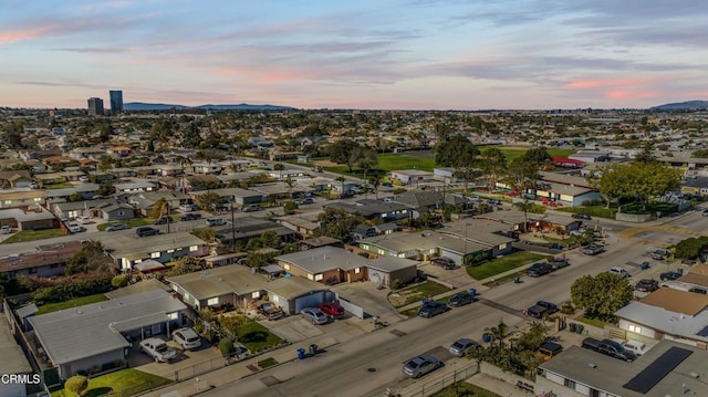 aerial view at dusk featuring a residential view