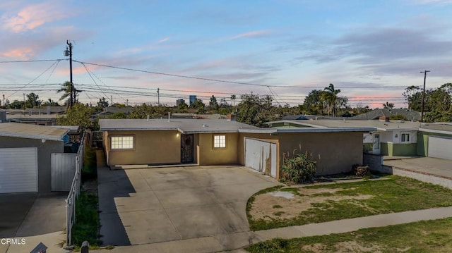 view of front facade featuring fence and stucco siding