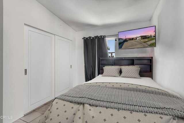 bedroom with a closet and tile patterned floors